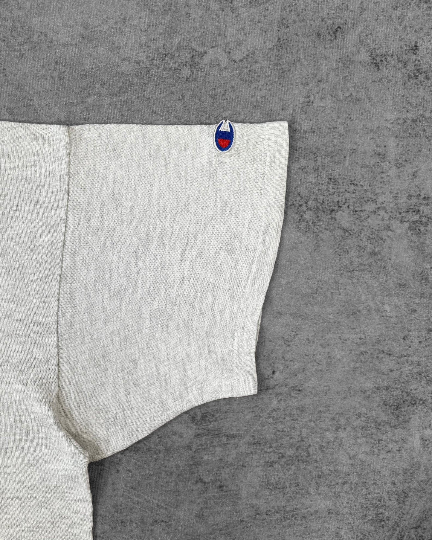 Fabric detail of the ash grey cotton and ribbed crewneck collar on the Champion t-shirt