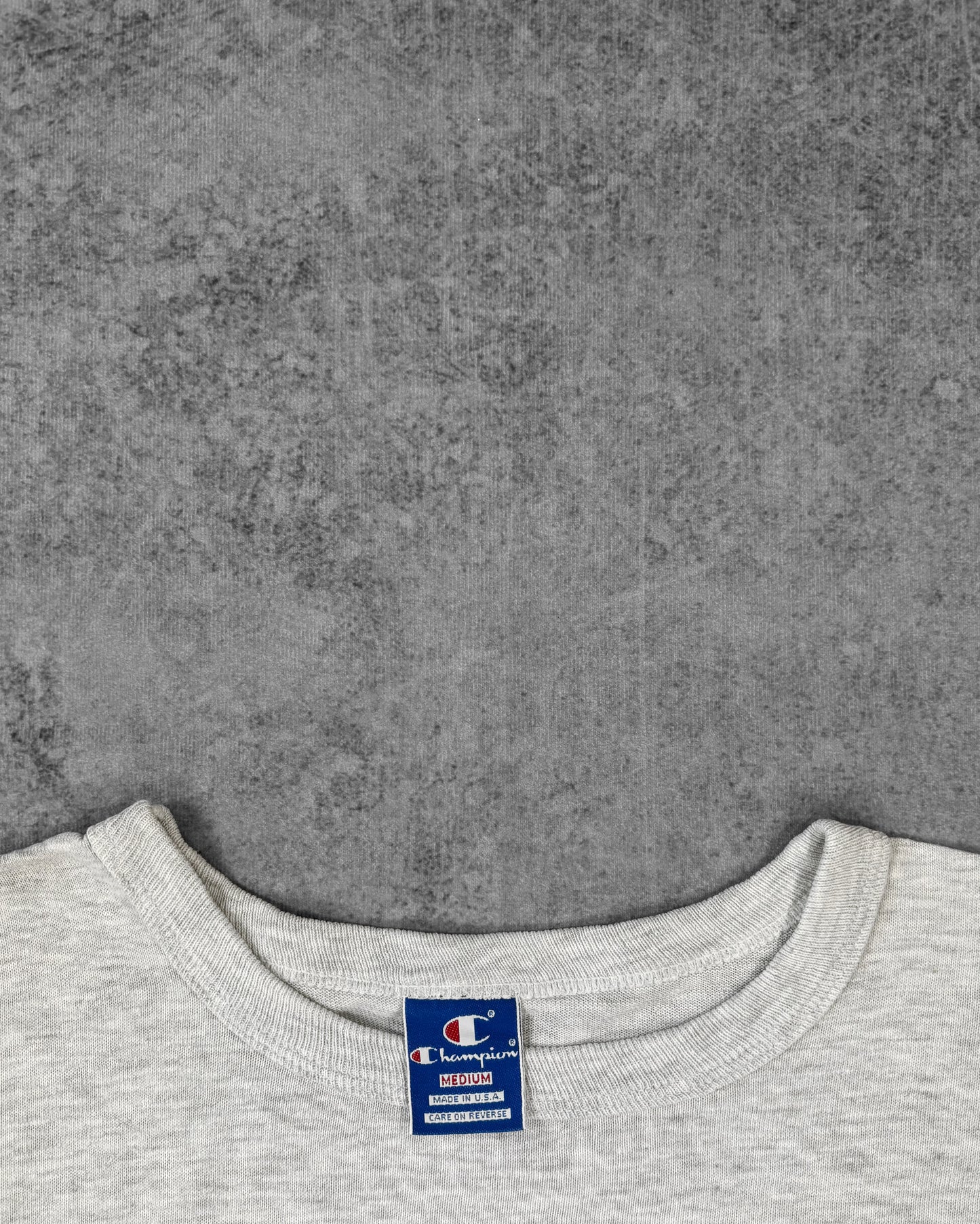 Sleeve detail showing the embroidered Champion 'C' patch