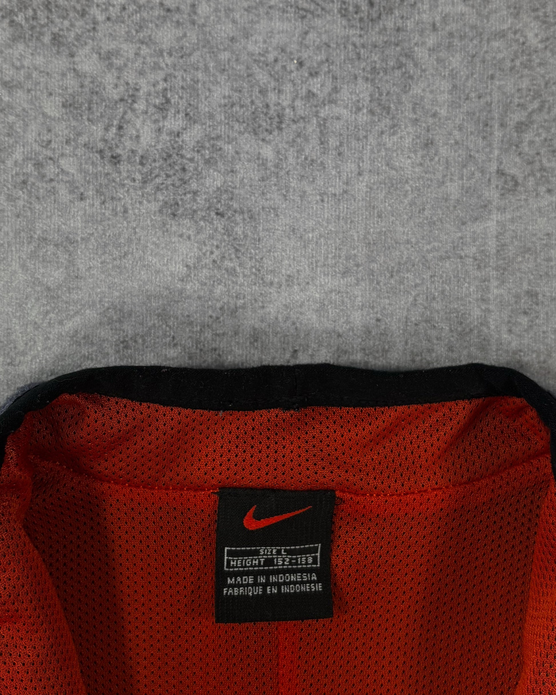 Fabric detail of the microfleece body and orange mesh interior panelling