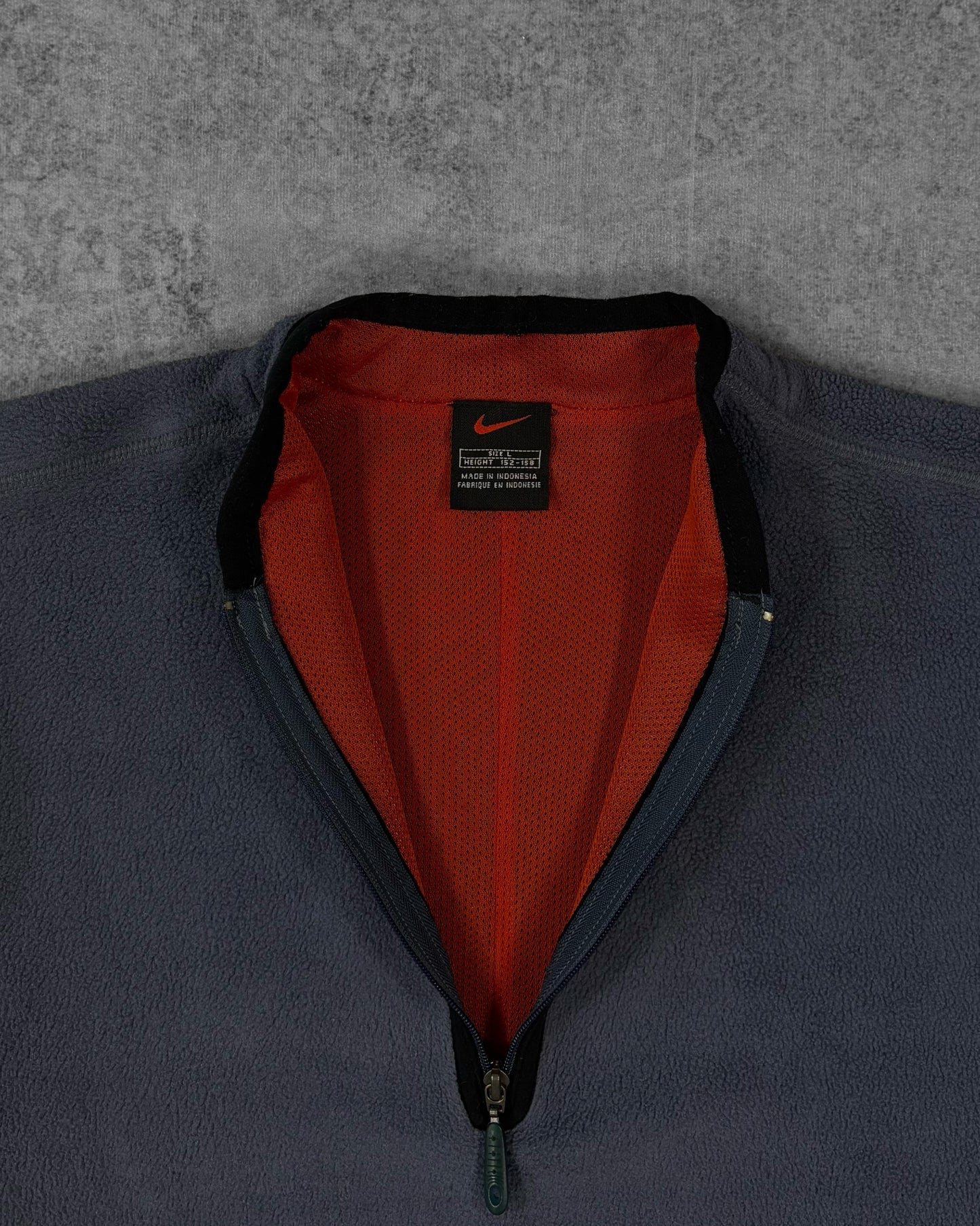 Label detail showing the Nike black and red tag inside the pullover