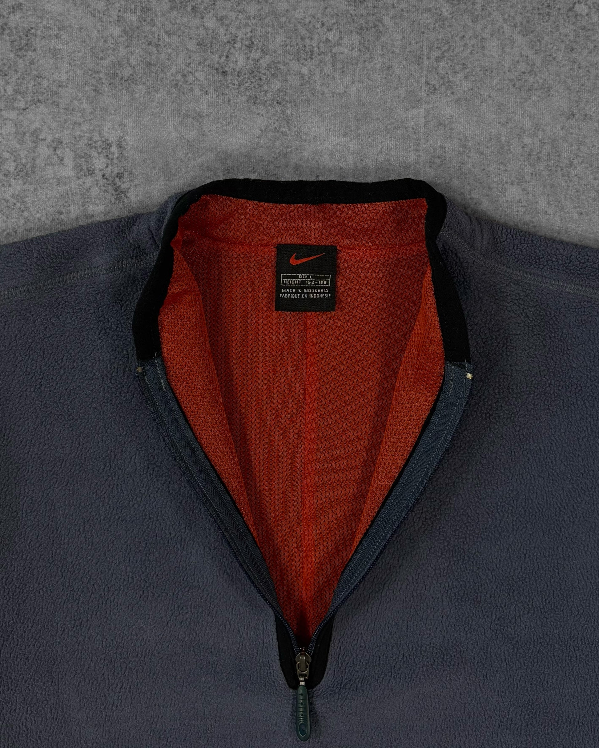 Label detail showing the Nike black and red tag inside the pullover