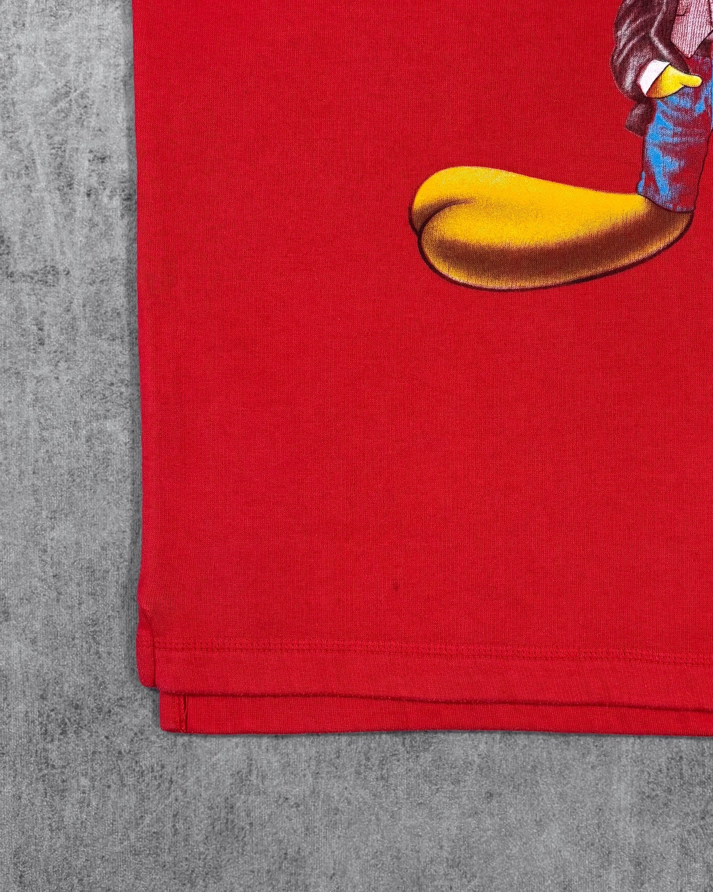 Side slit stitching detail on hem of vintage Tweety crewneck sweatshirt