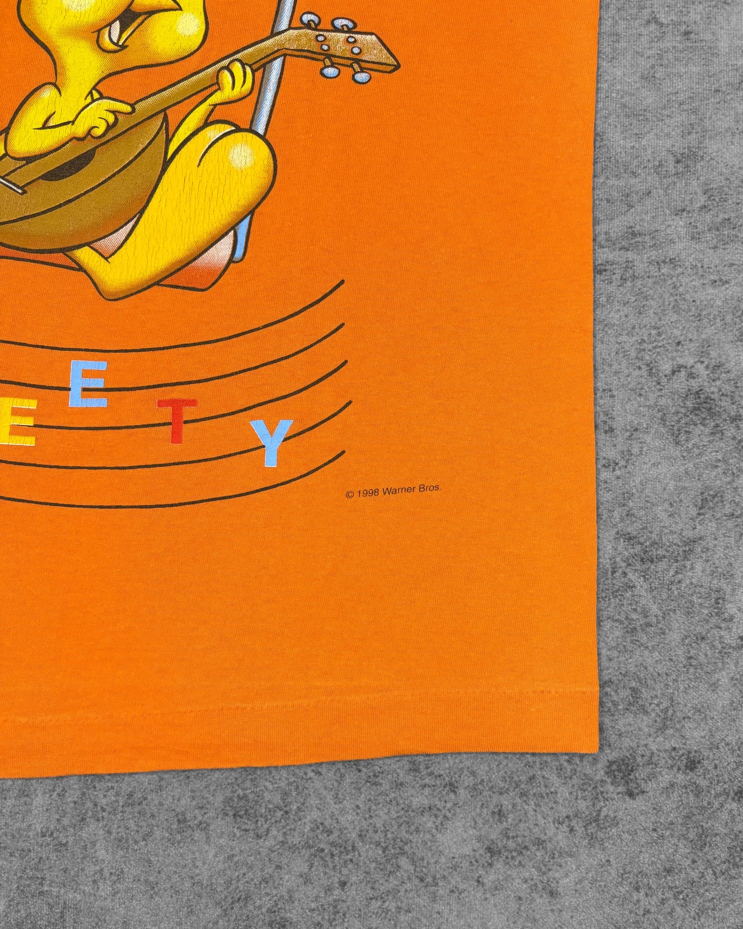 Composition tag detail showing 100% cotton and Fruit of the Loom branding
