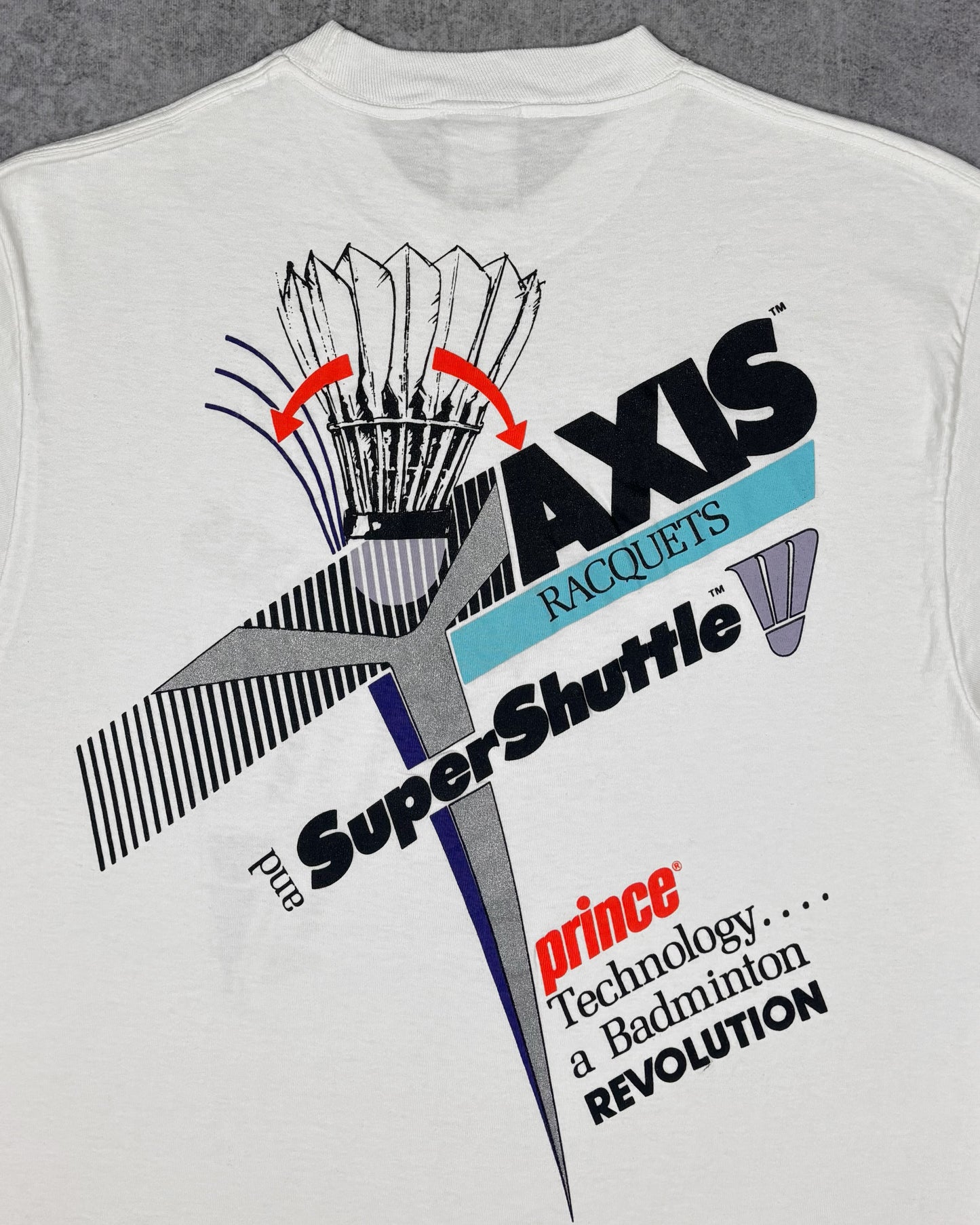 Print detail of the front chest graphic on the Prince AXIS badminton t-shirt