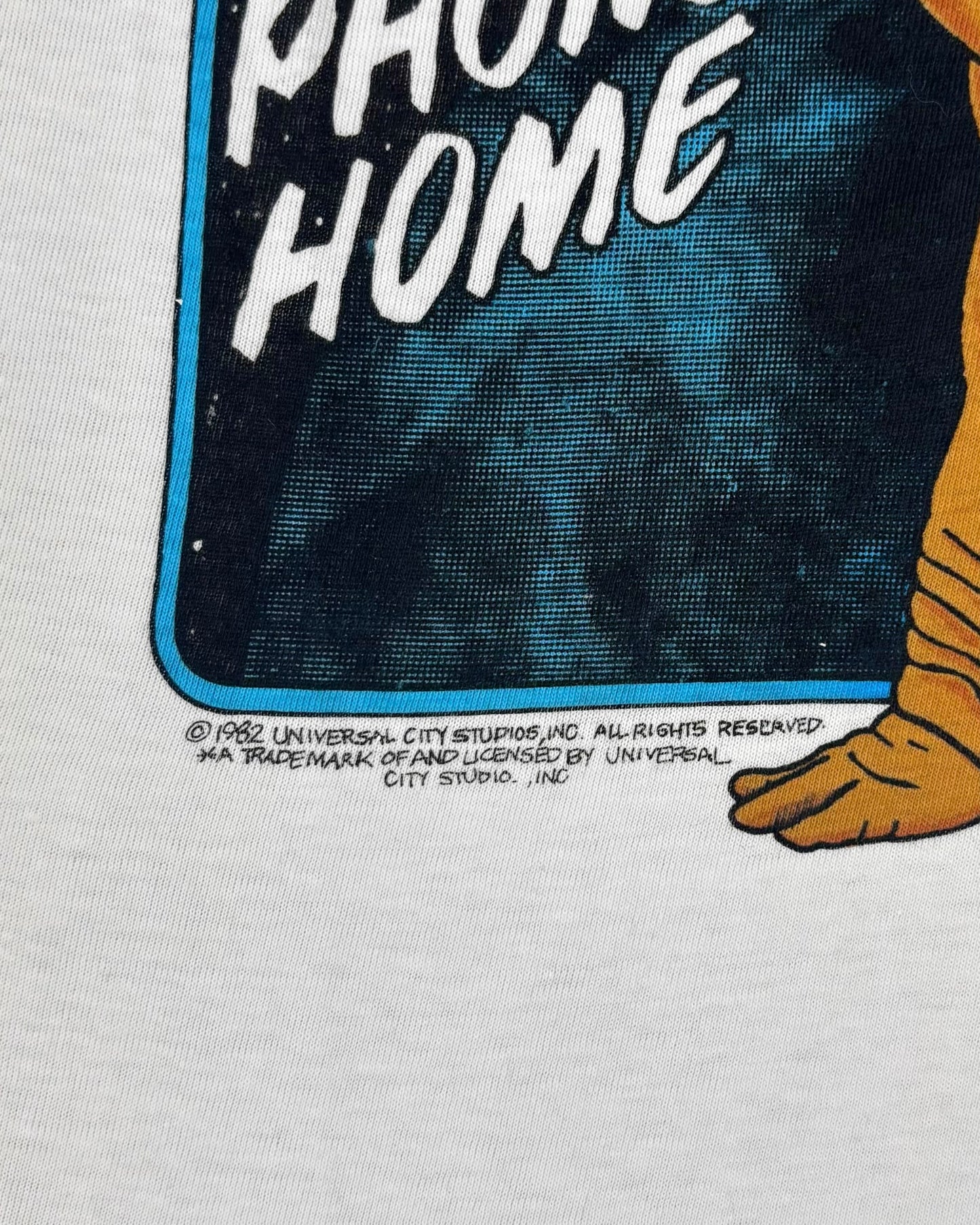 Label detail showing the Universal City Studios 1982 neck tag on the E.T. t-shirt