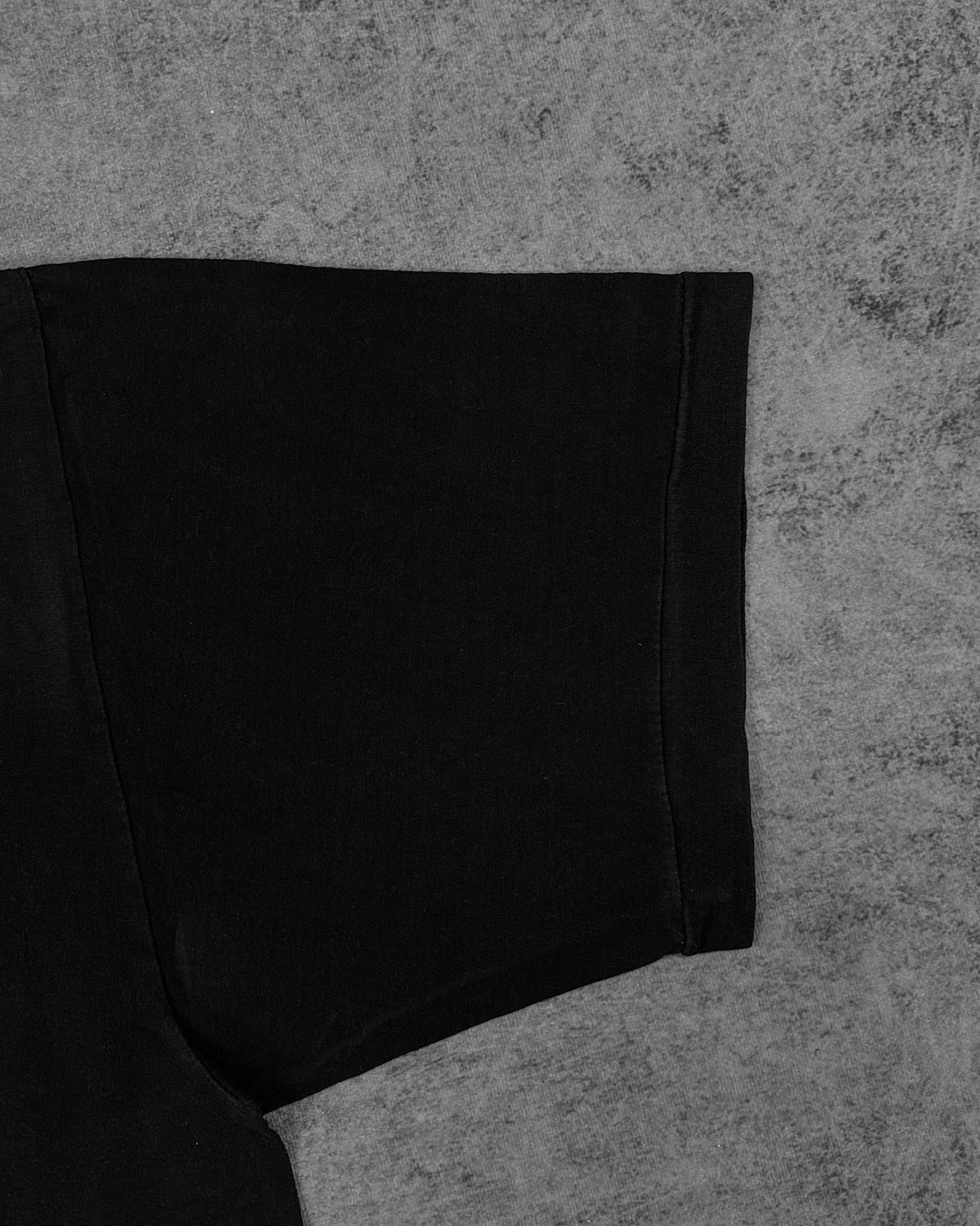 Black jersey fabric detail of vintage Wile E. Coyote t-shirt