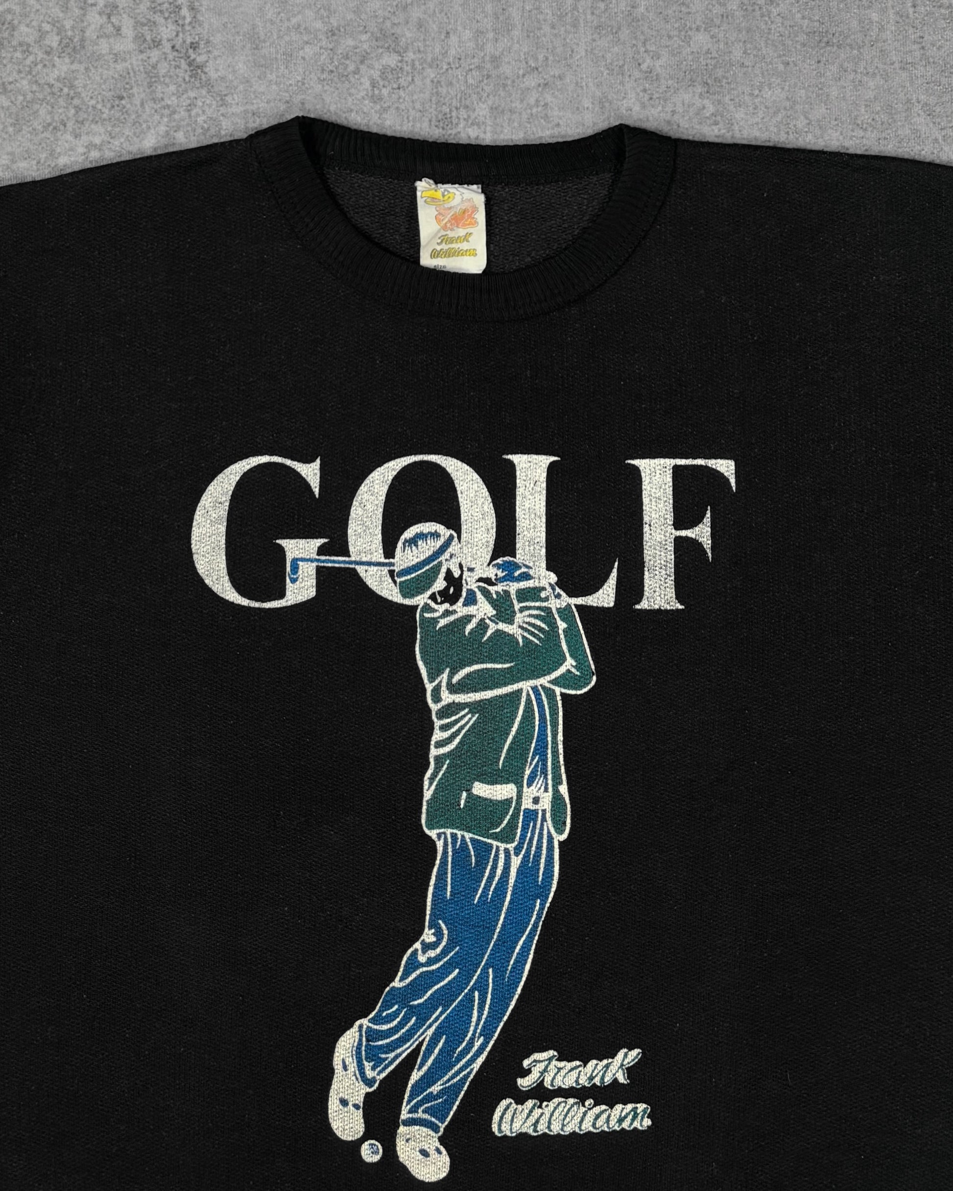 Close-up print detail of the screen-printed golfer graphic and 'GOLF' lettering on the Frank William crewneck sweatshirt