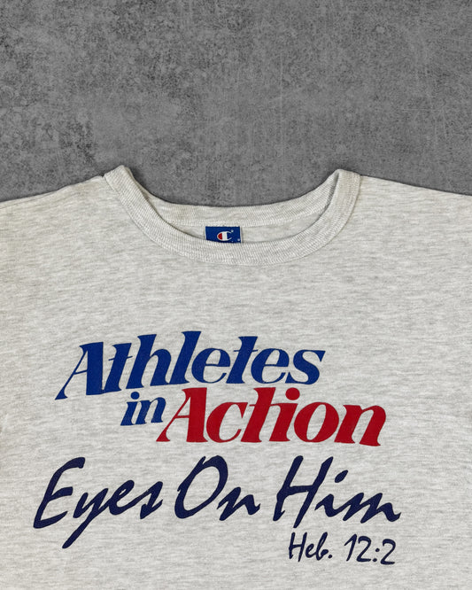 Print detail of the 'Athletes in Action - Eyes On Him - Heb. 12:2' graphic on the Champion t-shirt