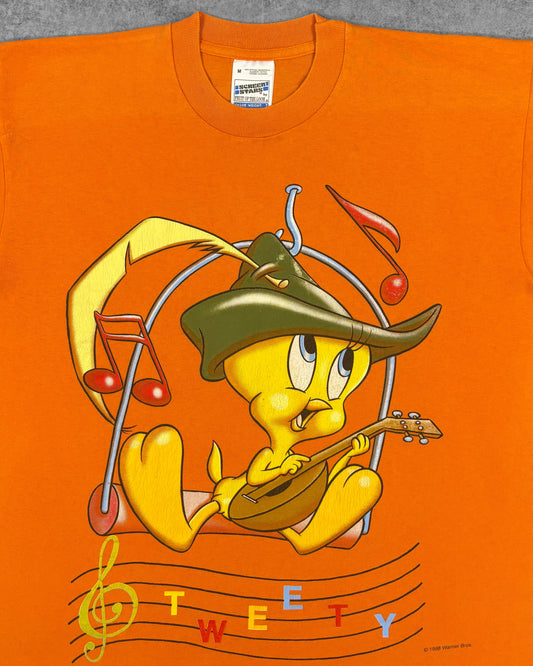 Close-up of Tweety troubadour graphic print with musical notes