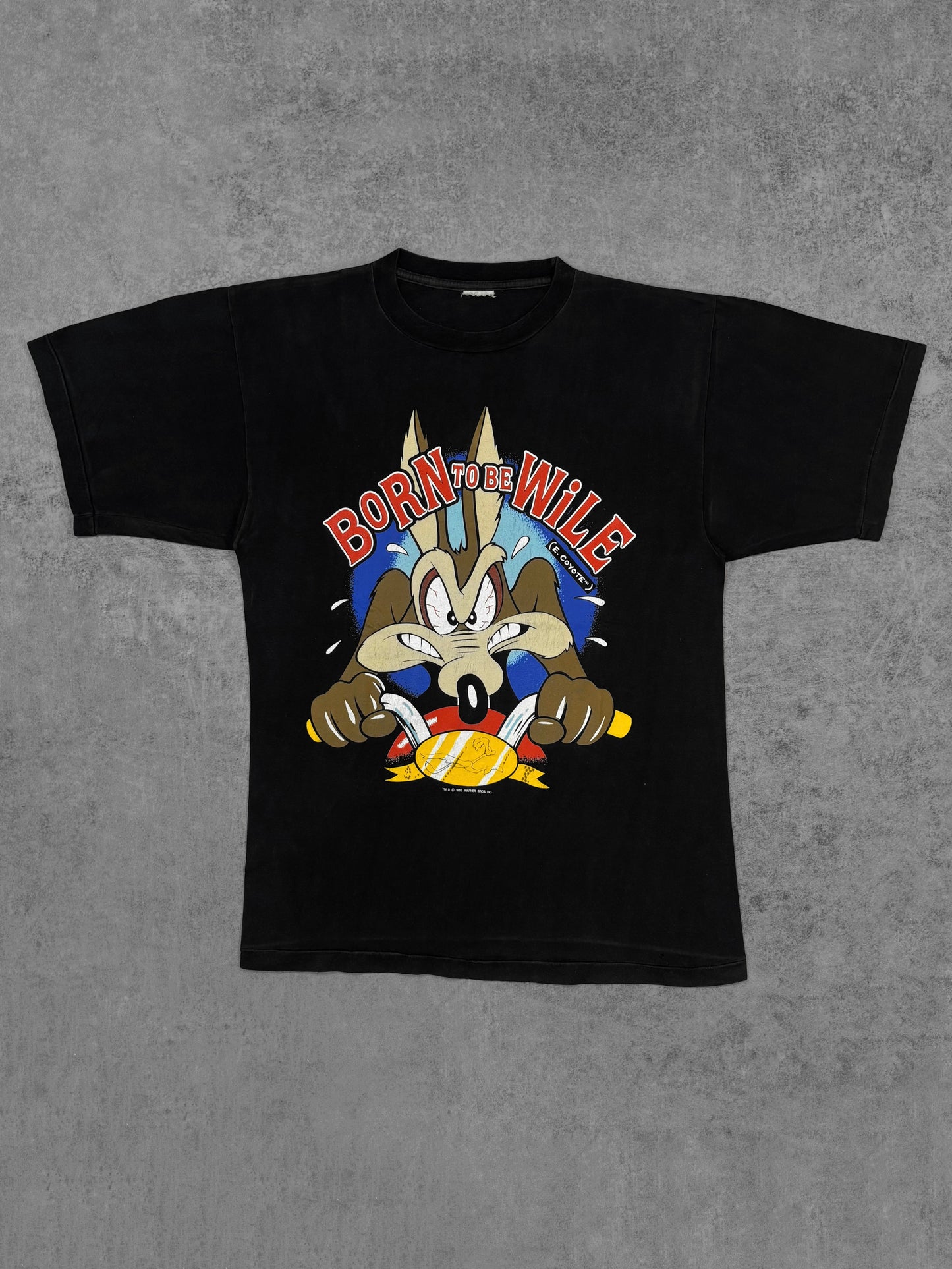 Front view of vintage 1989 Warner Bros Wile E. Coyote Born to Be Wile graphic t-shirt in black