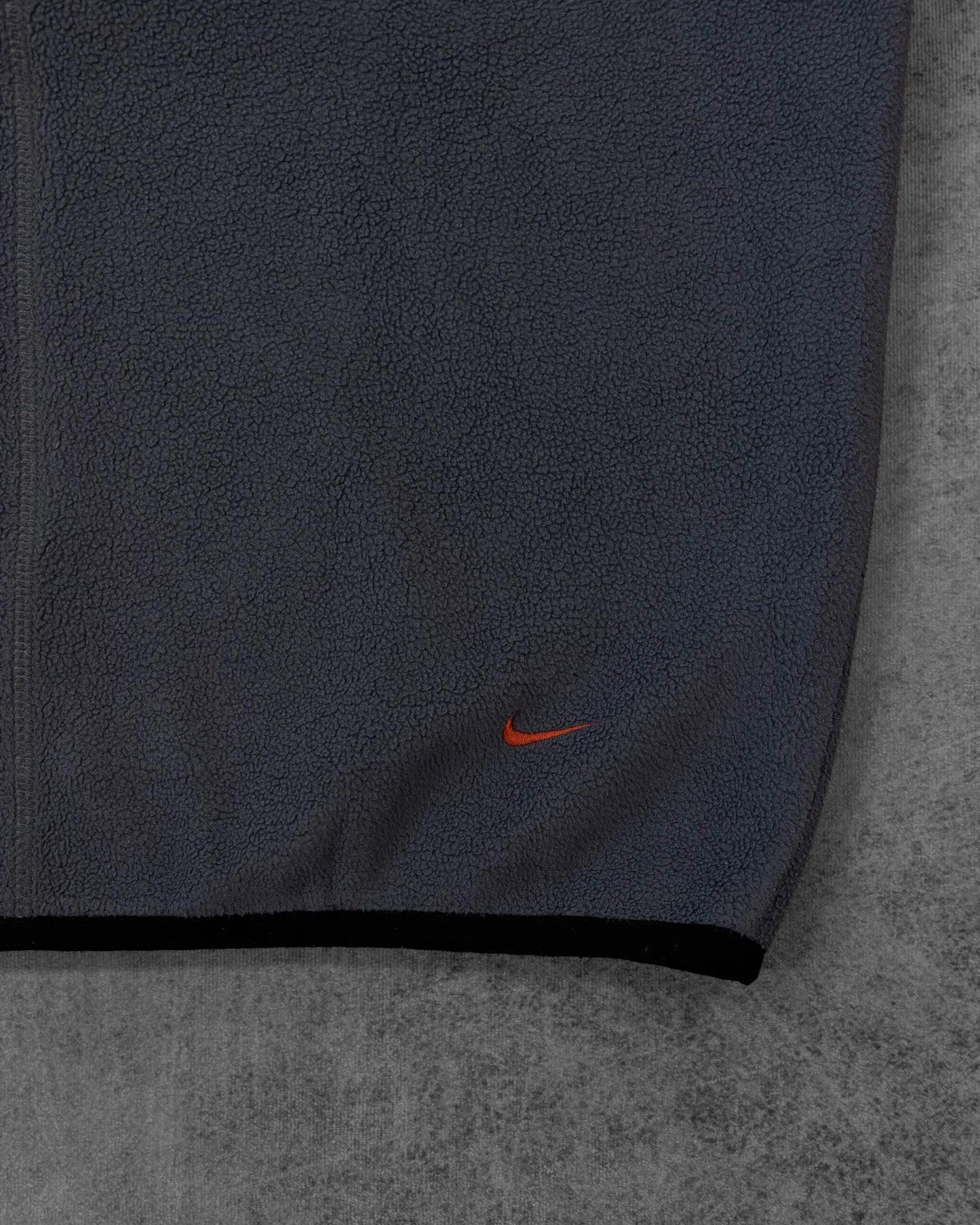 Detail of the vertical embroidered NIKE lettering on the sleeve
